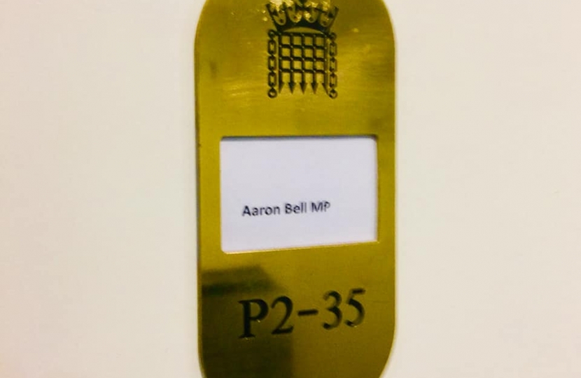 an image of the office's door with AARON BELL MP written on it