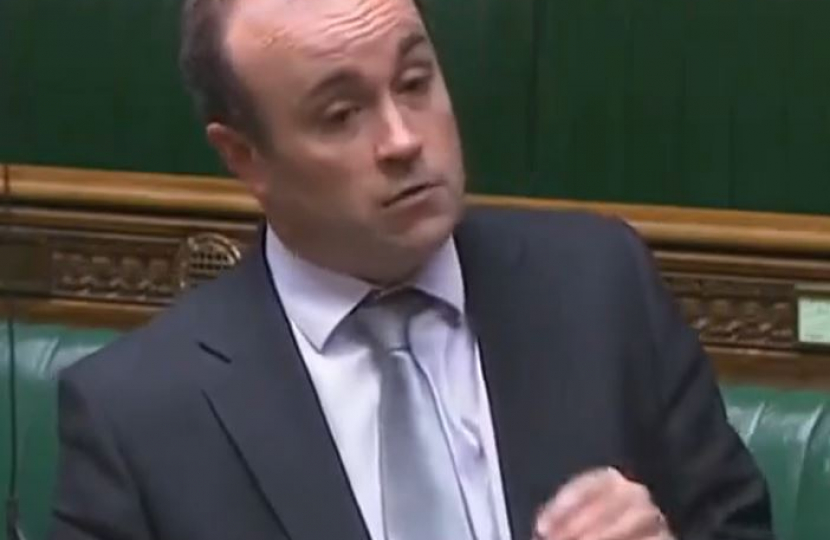 Aaron speaking in Parliament in December 2021