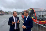 Aaron speaking with the Transport Secretary, Mark Harper outside a bus station